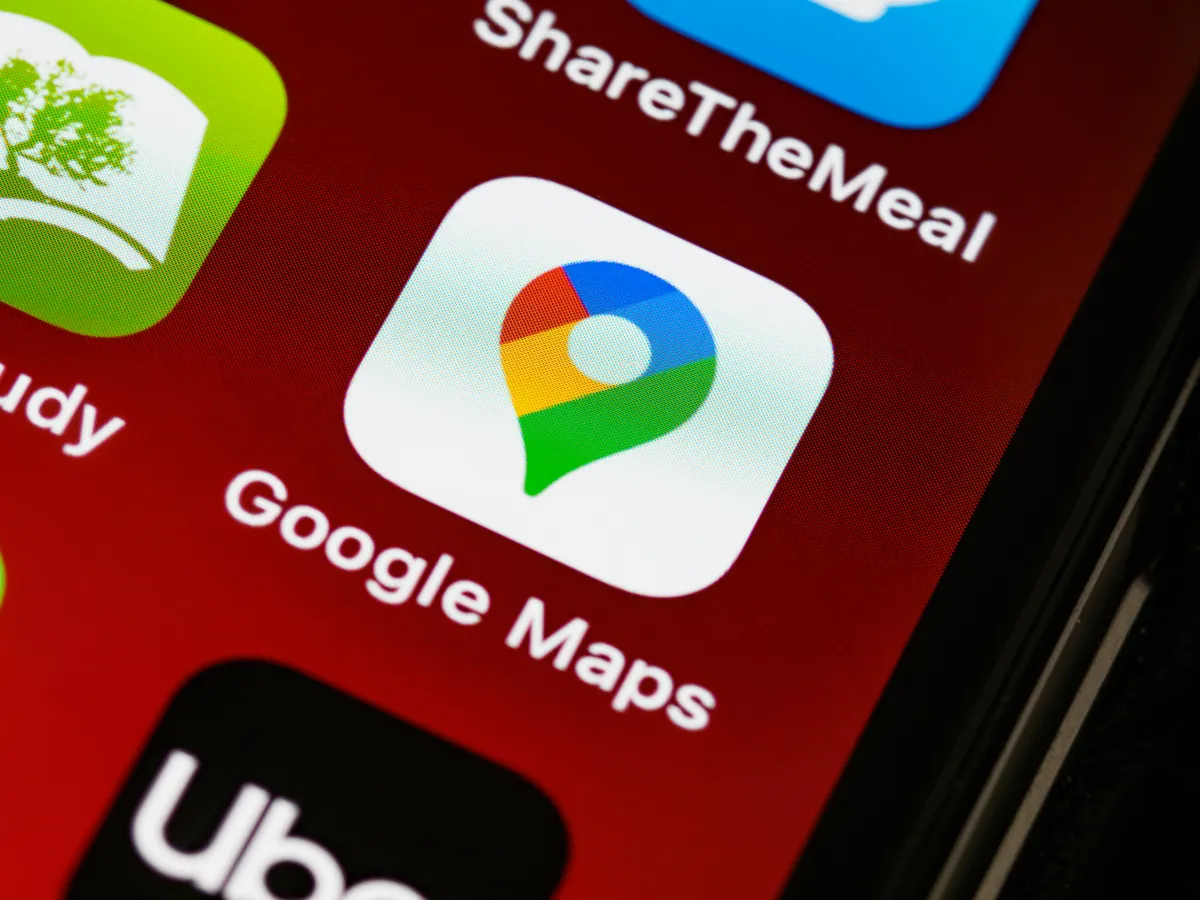 Google Maps app icon on a smartphone screen, representing local search visibility on Google