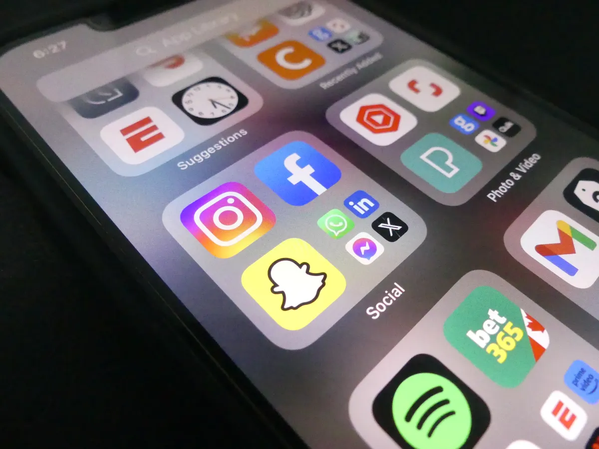 Smartphone screen showing social media apps including Instagram, Facebook and LinkedIn