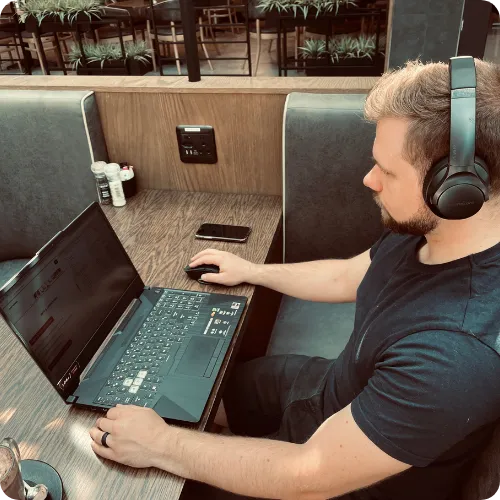Custom Sites owner working on a laptop, creating a new website.